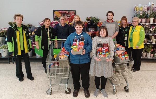 Asda staff presenting movie packs